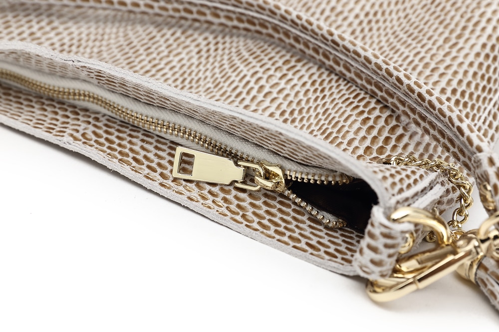 Leather shoulder bag with embossed snake pattern for women.