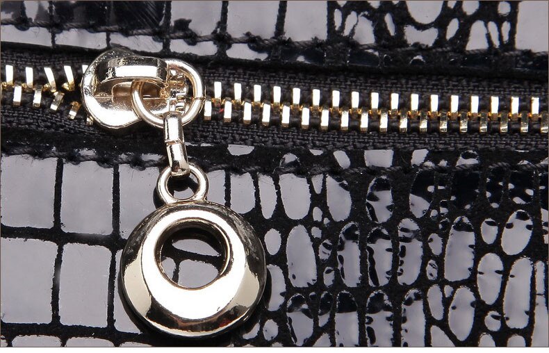 Genuine leather girl's handbag with shiny crocodile pattern.
